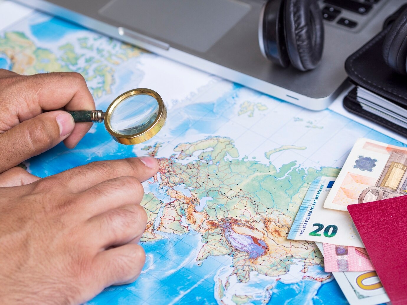imgi 9 man looking map with magnifying glass 23 2148256057